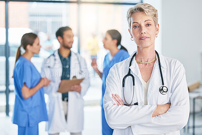 Buy stock photo Shot of a mature female doctor standing in a hospital
