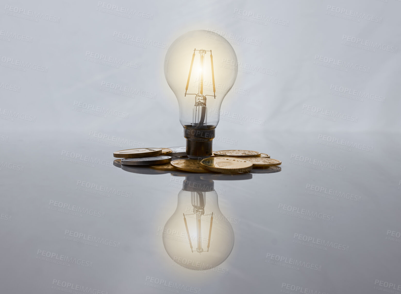 Buy stock photo Studio shot of a coin  and lightbulb against a grey background