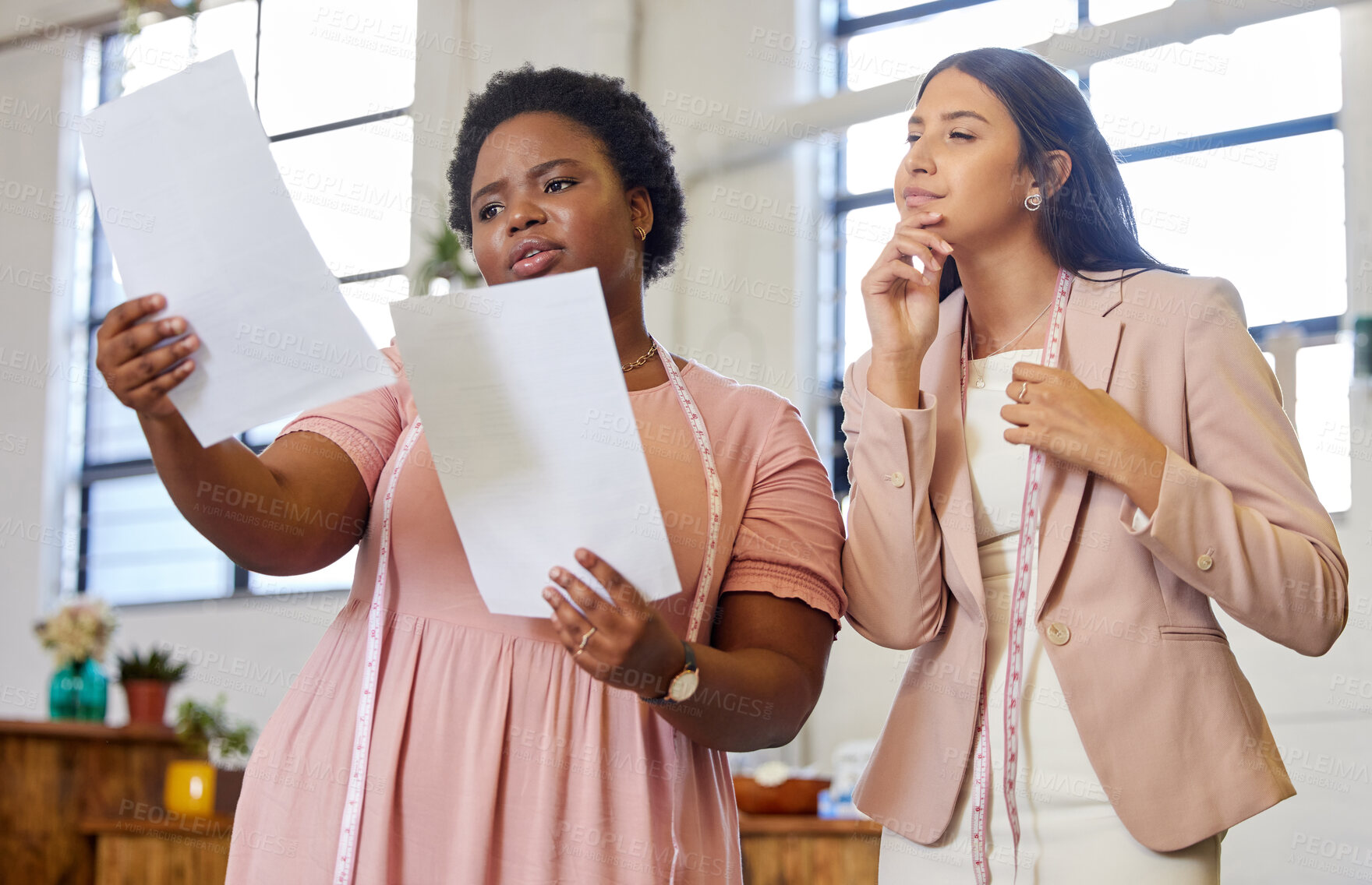 Buy stock photo Planning, woman colleagues and talking with thinking, tape and fashion designer in workspace. Pensive, communication and teamwork for coworkers and finance, office or tailor with small business owner