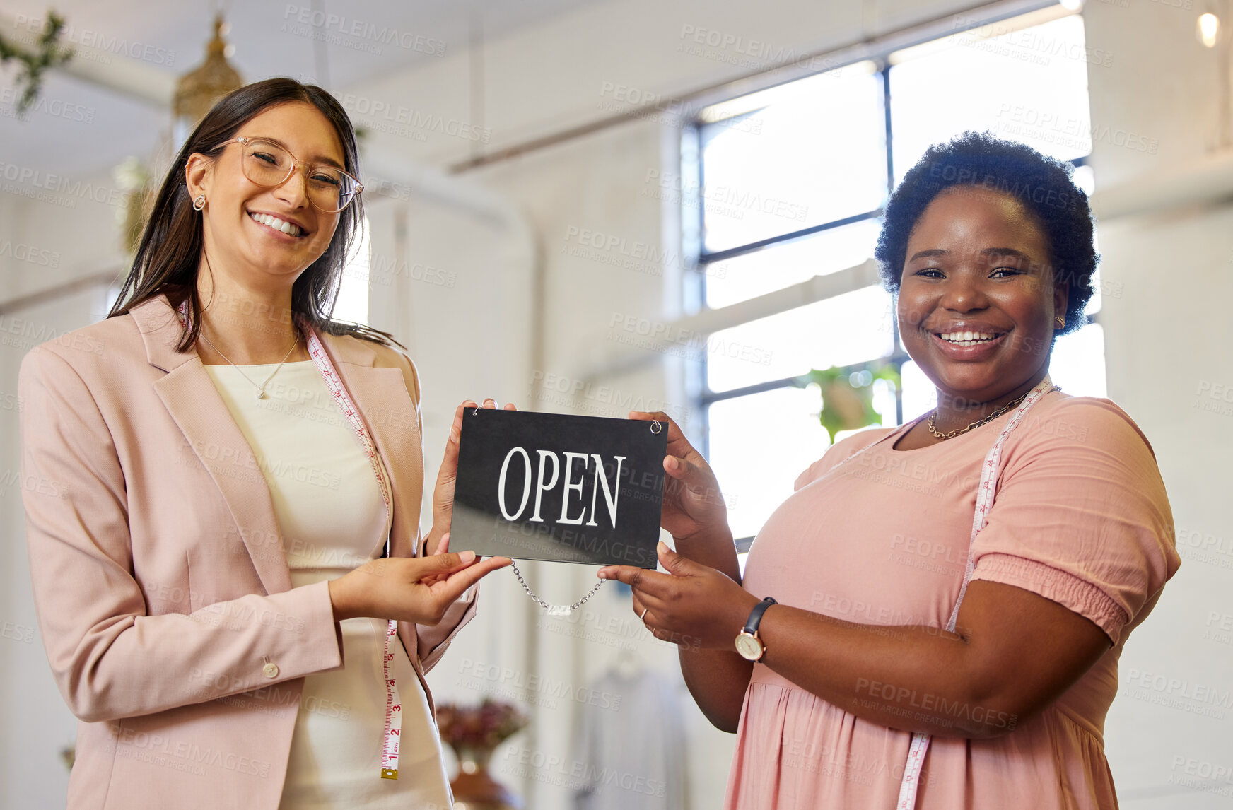 Buy stock photo Success, portrait and women with open sign for small business, celebration and achievement in fashion. Smile, tailor and happy team at launch of shop for designer clothes, retail or creative startup