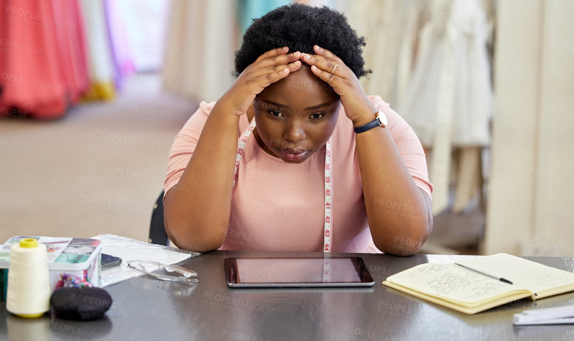 Buy stock photo Stressed, black woman and designer for sewing in workshop for tired, anxiety and crisis with design for deadline of retail production. Frustrated, tailor and pain for creative burnout, doubt of idea