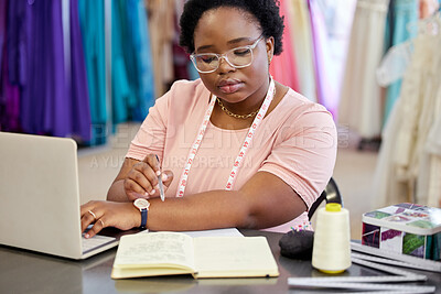 Buy stock photo Woman, fashion designer and book with laptop in workshop for planning, fitting information or writing. Creative, small business and female person with tape measure for ideas, boutique or seamstress