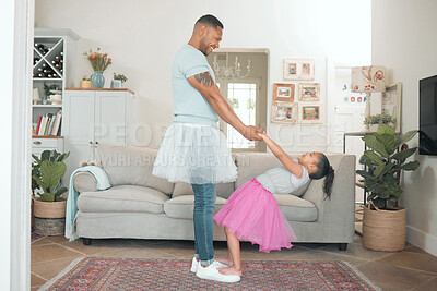 Buy stock photo Full length shot of an adorable little girl bonding with her father while dancing with him in the living room