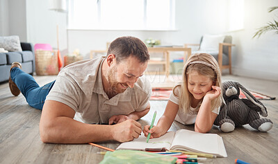 Buy stock photo Shot of a young father and daughter drawing together at home