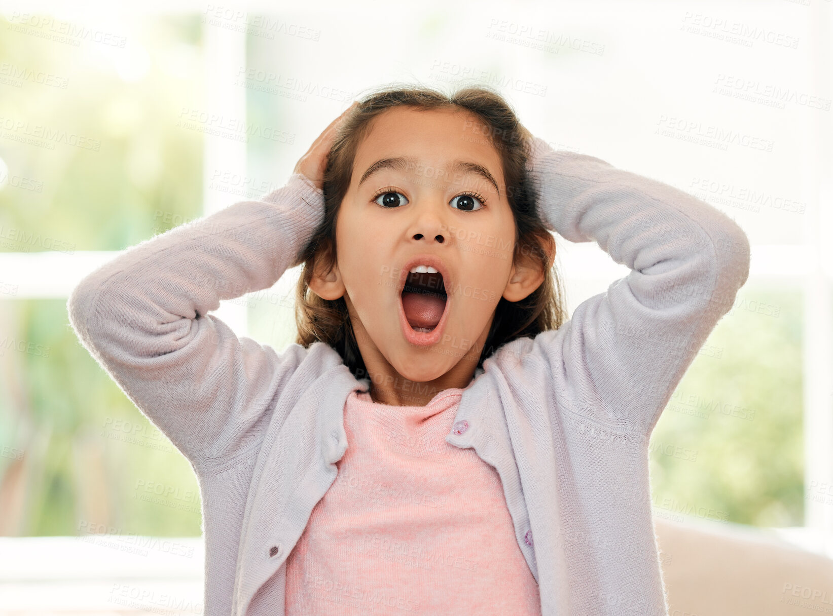 Buy stock photo Shot of a little girl looking shocked at home