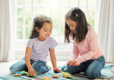 Buy stock photo Shot of two little siblings playing with toys at home