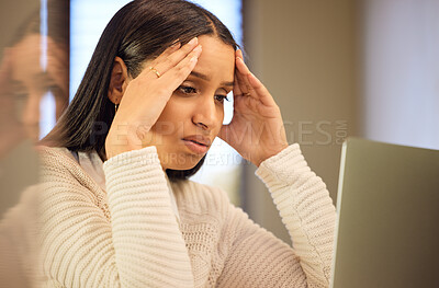 Buy stock photo Cropped shot of an attractive young woman looking stressed while studying at home