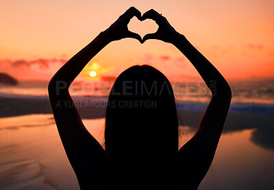 Buy stock photo Woman, silhouette and sunset at beach with heart hands for love, care and kindness with sign, summer and dusk. Girl, person and ocean with symbol, emoji or icon on vacation, nature or outdoor in dark