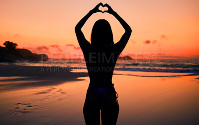 Buy stock photo Woman, silhouette and sunset by water with heart hands for love, care and kindness with sign, summer and body. Girl, person and beach with symbol, emoji or icon on vacation, ocean or outdoor at dusk