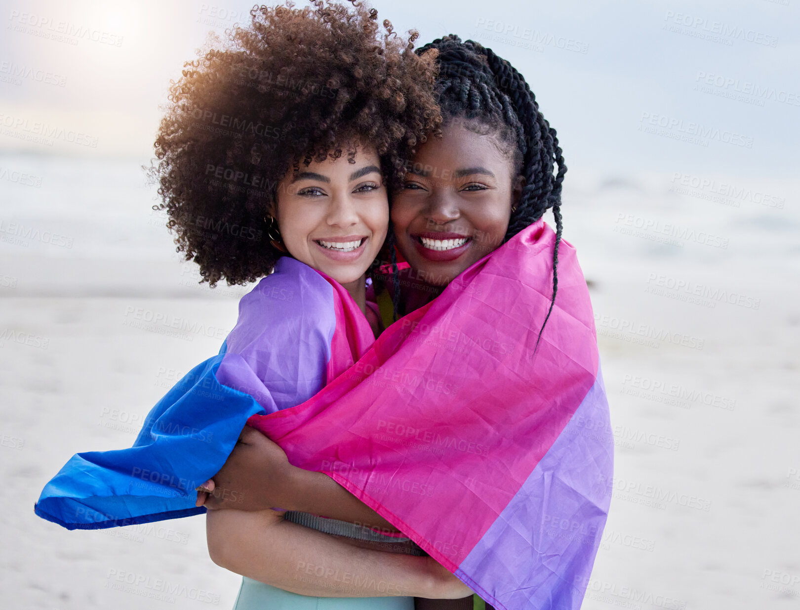 Buy stock photo Love, beach and portrait of lesbian couple with flag, hug and happy holiday together in Pride Month. Smile, embrace and lgbt women relax on ocean vacation for romantic date, support and trans culture