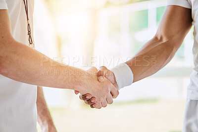 Buy stock photo Cropped shot of an unrecognizable male tennis player and his coach shaking hands in the clubhouse