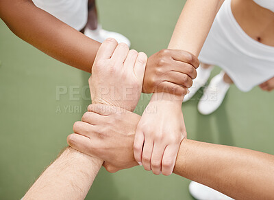 Buy stock photo High angle shot of four unrecognizable tennis players standing in a huddle on the court