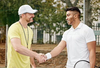 Buy stock photo Cropped shot of a handsome young male tennis player shaking hands with his coach outside on the court