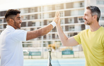 Buy stock photo Cropped shot of a handsome young male tennis player high fiving his coach while standing outside on a court