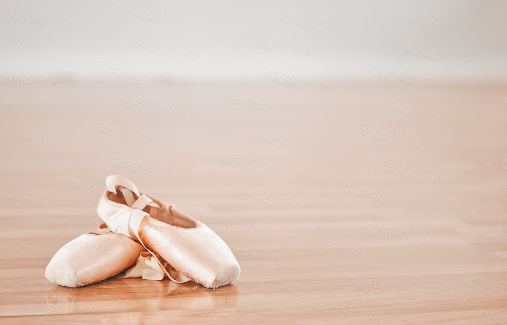 Buy stock photo Shot of a pair of ballet shoes in a dance studio