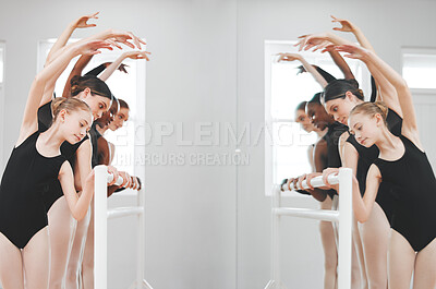 Buy stock photo Shot of a group of ballet dancers leaning against a barre