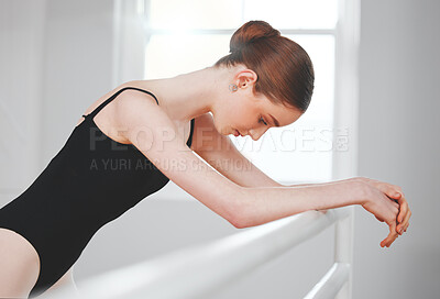 Buy stock photo Shot of a young ballet dancer leaning against a barre