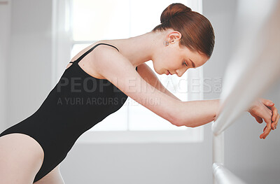 Buy stock photo Shot of a young ballet dancer leaning against a barre