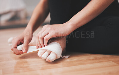 Buy stock photo Shot of an unrecognizable ballet dancer wrapping her feet with bandage
