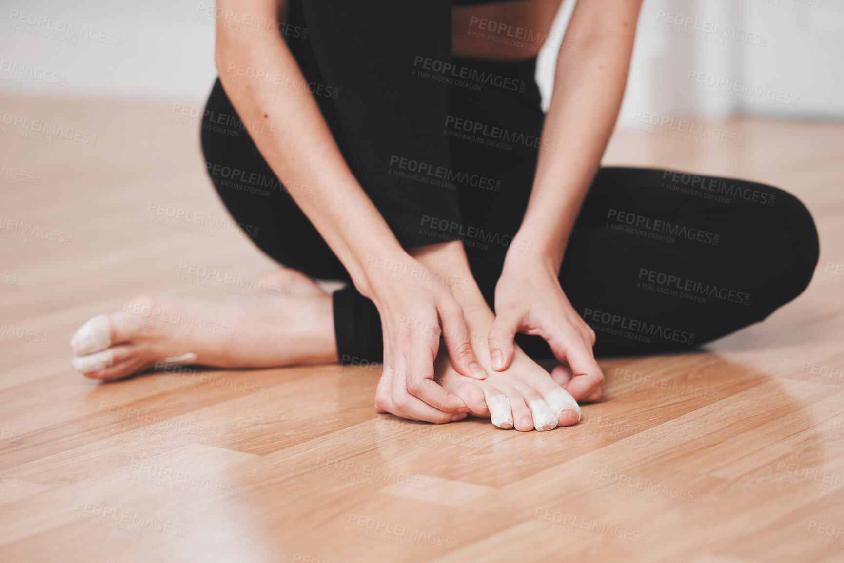 Buy stock photo Shot of a young ballet dancer rubbing her feet