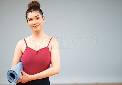 Buy stock photo Shot of a woman holding a yoga mat about to take a class