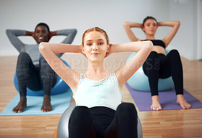 Buy stock photo Shot of a group of students performing crunches during a pilates class