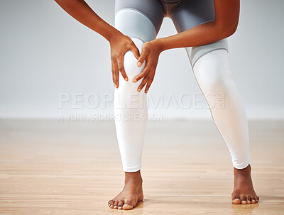 Buy stock photo Shot of a woman inspecting her knee after an injury