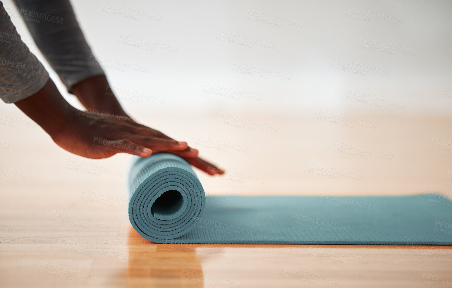 Buy stock photo Fitness, hands and yoga mat with person on wooden floor of studio for start of wellness routine. Exercise, pilates and preparation with yogi in home gym for awareness, balance or holistic health