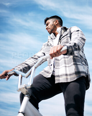 Buy stock photo Cropped shot of a handsome young man riding his BMX outside