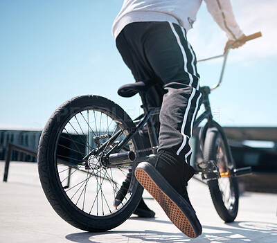 Buy stock photo Stunt, legs of person and riding bicycle for hobby, daily activity and cycling for fun. Outside, street or road and cyclist on a bike for exercise, leisure time or freedom for playing with biker