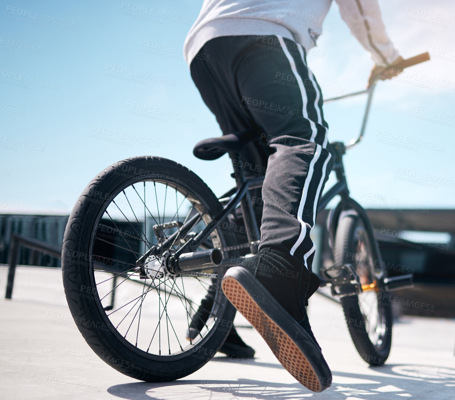 Buy stock photo Stunt, legs of person and riding bicycle for hobby, daily activity and cycling for fun. Outside, street or road and cyclist on a bike for exercise, leisure time or freedom for playing with biker