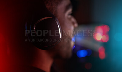 Buy stock photo Gaming, headphones and man in esports at night in competition with online video games. Gamer, nerd and person in dark room with neon lights and live streaming cyber contest on computer in home