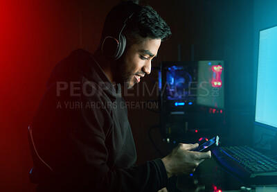 Buy stock photo Gamer, man and texting with phone with in night, smile or reading for invitation link to rpg contest. Person, smartphone and pro gaming with chat, challenge and esports app by computer in dark home