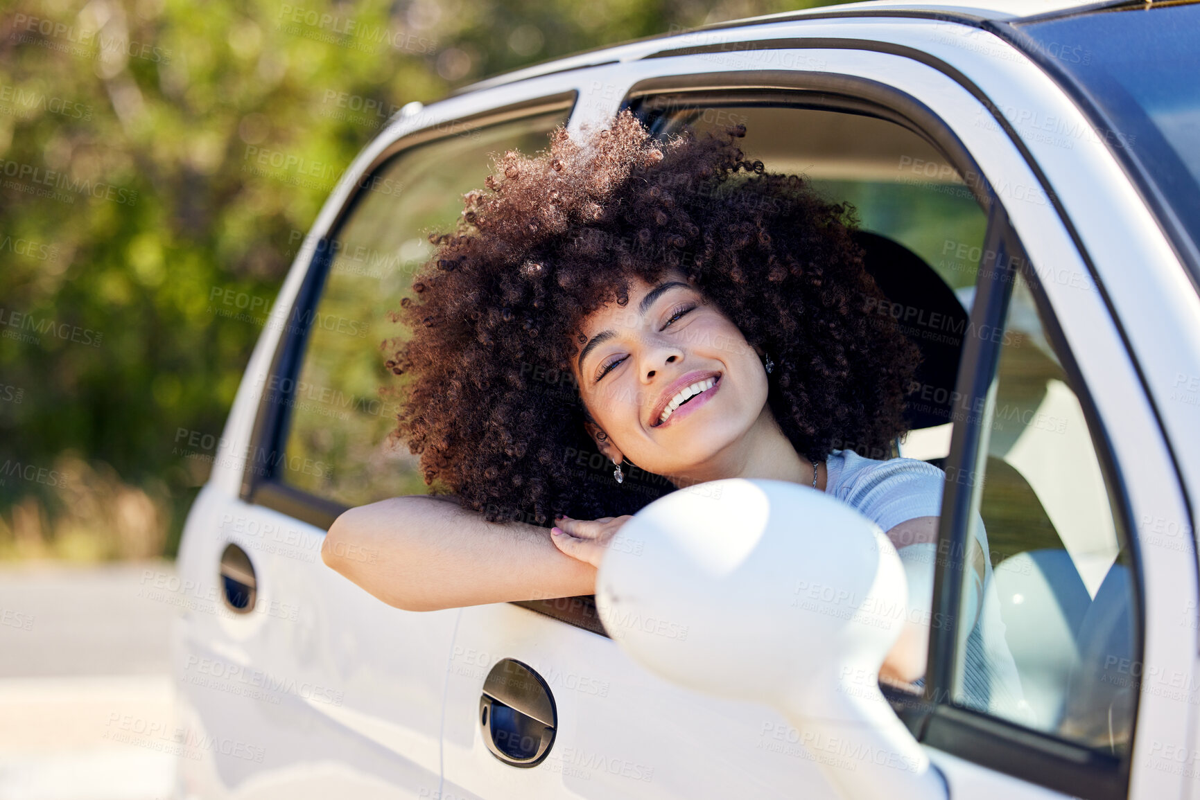 Buy stock photo Shot of a beautiful young woman enjoying an adventurous ride in a car