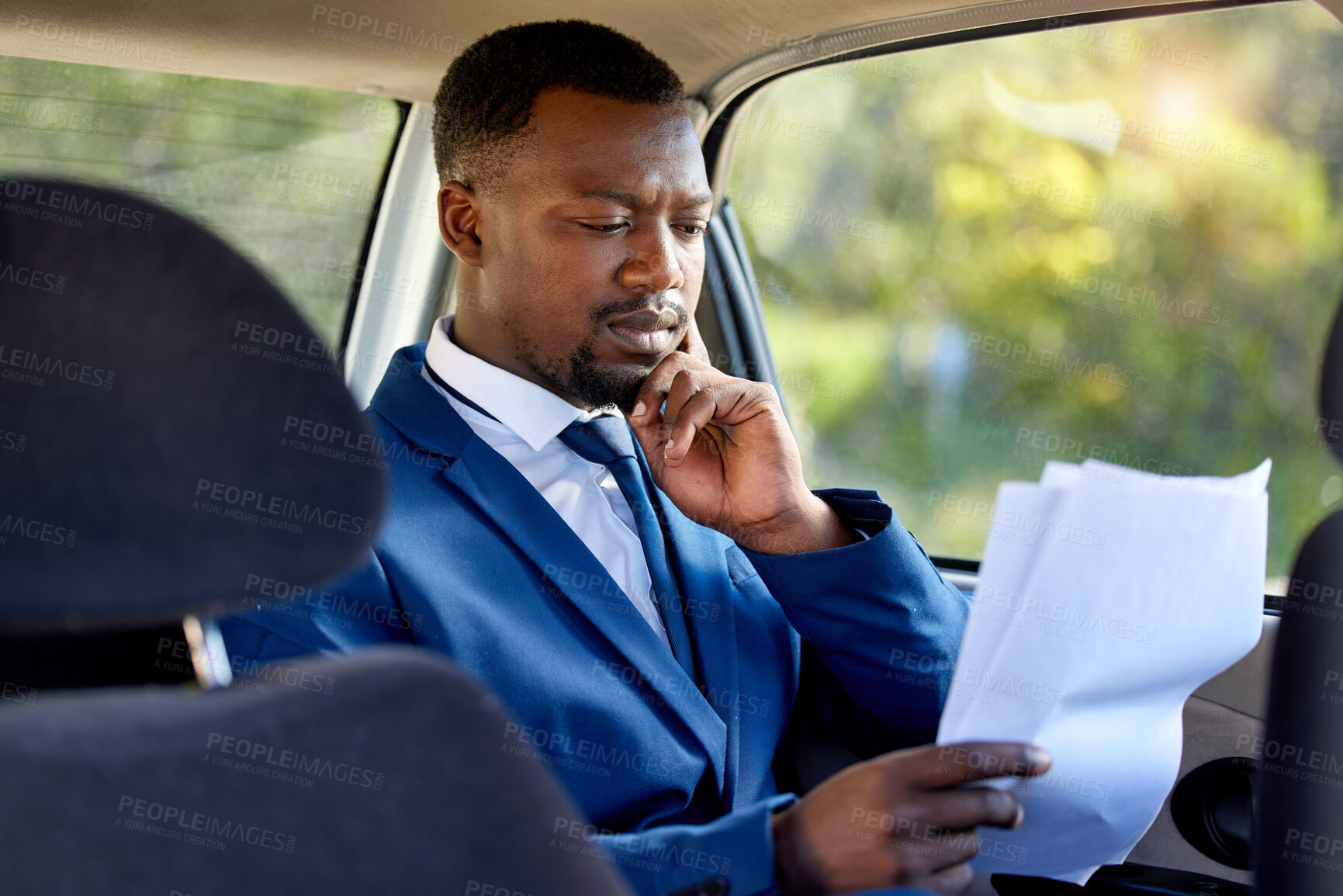 Buy stock photo Car, taxi and business black man with documents for commute, journey and transport. Corporate, professional and person thinking in vehicle for travel with paperwork for working, planning and review