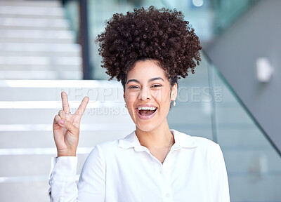 Buy stock photo Shot of a young businesswoman showing the peace sign