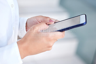 Buy stock photo Cropped shot of an unrecognizable woman using her cellphone at the office