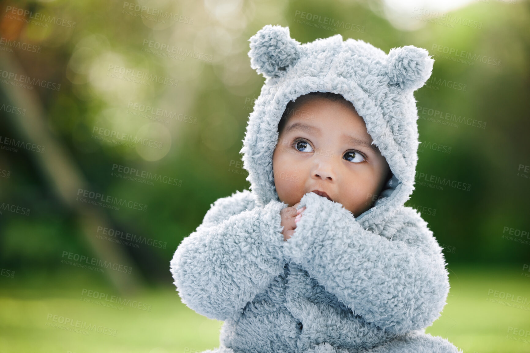 Buy stock photo Baby boy, adorable and cute with jacket in nature for fashion, cotton or furry outfit. Little infant, innocent child or kid thinking in wonder or thought with bear ears for outdoor childhood at park