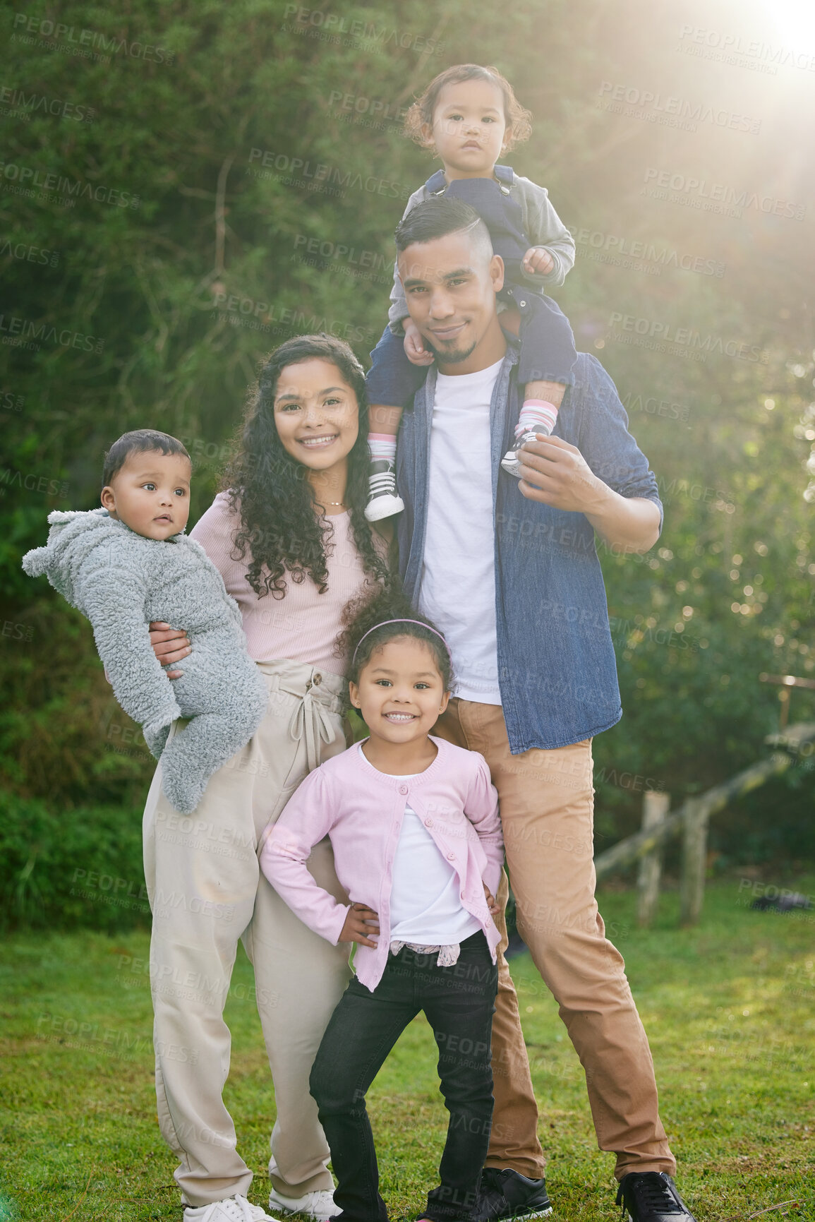 Buy stock photo Portrait, happy family and parents outdoor with children on vacation or holiday in garden together. People, mother and father with kids at park for support, piggyback and love with siblings in Brazil