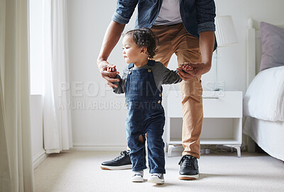 Buy stock photo Child, dad and learning to walk in home with mobility development and baby steps with care. Love, support and helping parent with skills, standing and family together in bedroom with holding hands