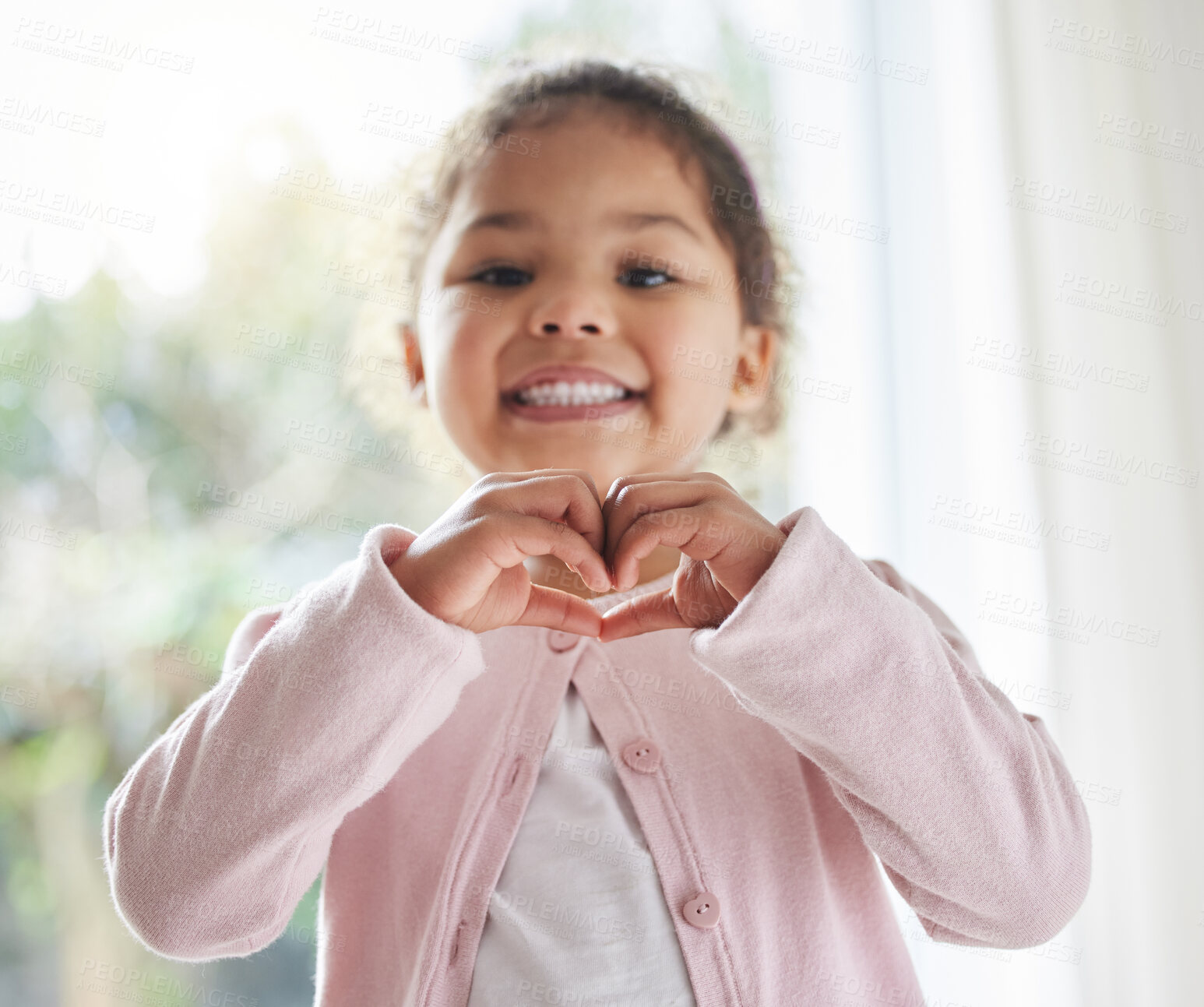 Buy stock photo Girl, child and heart hands in house portrait, love symbol and sign for kindness or peace in lounge. Female person, kid and emoji for support or thank you gesture, home and shape for care or icon