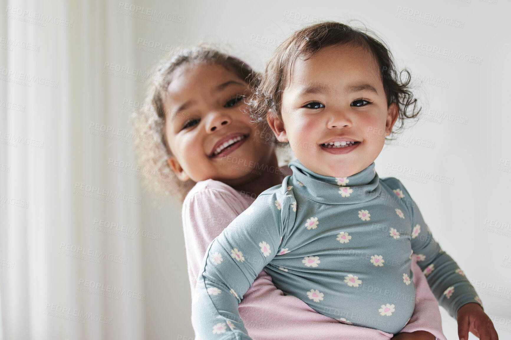 Buy stock photo Portrait, hug and a girl holding sister for love, care and bonding as siblings in a house. Smile, family and a child hugging a little kid together for affection, playing and happiness in childhood