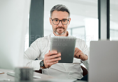 Buy stock photo Mature man, business and tablet at desk in office for planning research, online report or scroll information. Entrepreneur, digital news and software update for social network, reading review and app