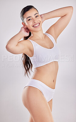 Buy stock photo Shot of a fit young woman posing in her underwear against a studio background