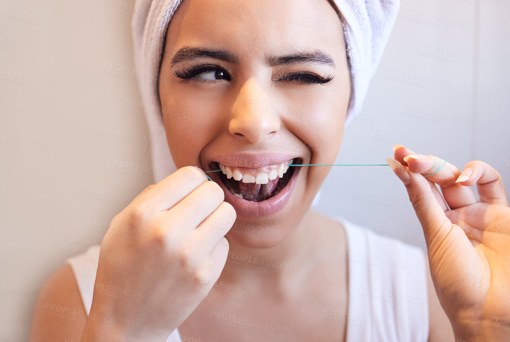 Buy stock photo Dental, wink and woman flossing teeth for cleaning, health or oral hygiene in home bathroom. Tooth care, happy face and thread in mouth for orthodontics, morning routine or fresh breath for wellness