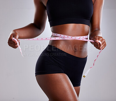 Buy stock photo Studio, fitness and black woman with tape for diet, health and wellness by mockup space. Female model, tracking and measure waist for progress, body goals results and benefits by gray background