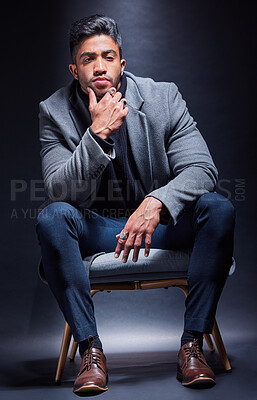 Buy stock photo Gangster, portrait and man with fashion in chair on studio, dark background or thinking of power. Serious, person and cool style with luxury jewellery, ring and criminal in mob or mafia with wealth