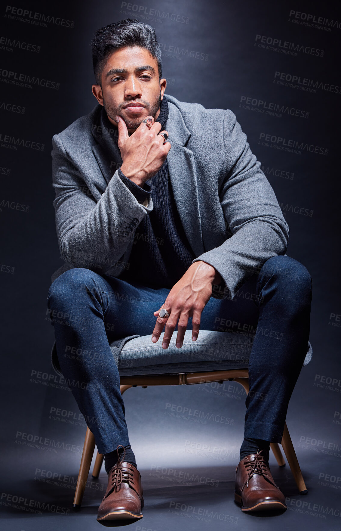 Buy stock photo Gangster, portrait and man with fashion in chair on studio, dark background or thinking of power. Serious, person and cool style with luxury jewellery, ring and criminal in mob or mafia with wealth