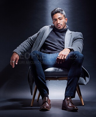 Buy stock photo Mafia, portrait and man with fashion in chair on studio, dark background or gangster with power. Serious, person and style with luxury jewellery, ring and criminal in mob or businessman with wealth