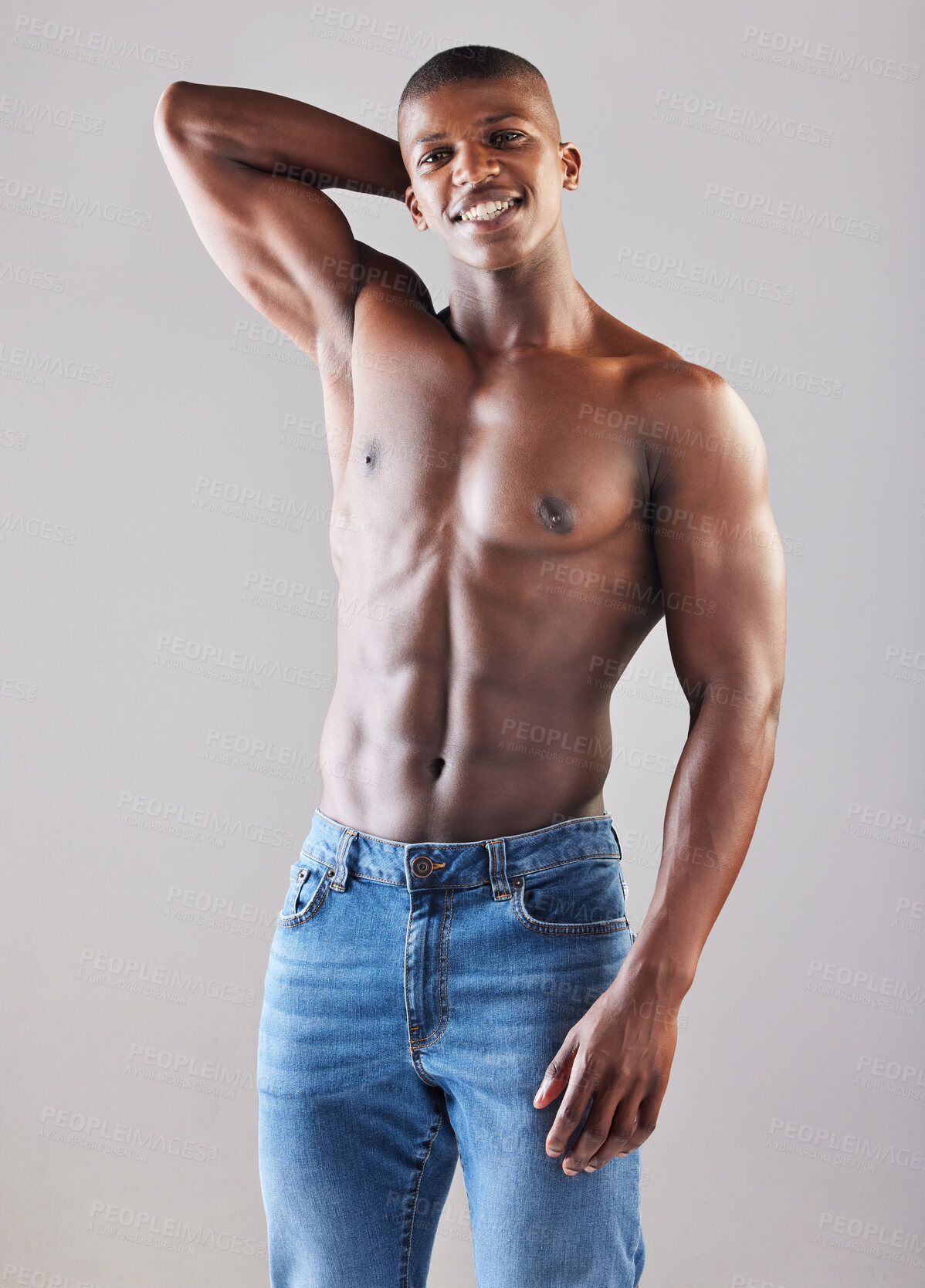 Buy stock photo Studio portrait of a muscular young man posing against a grey background